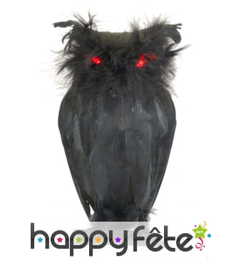 Chouette noire avec yeux lumineux